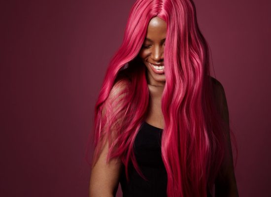 Mujer con el cabello rosado sonriendo
